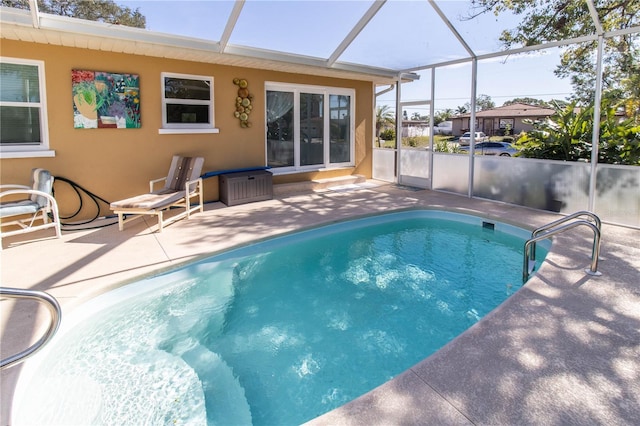 view of pool with a lanai and a patio area