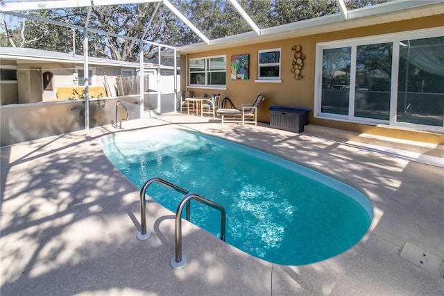 view of swimming pool with a patio and glass enclosure