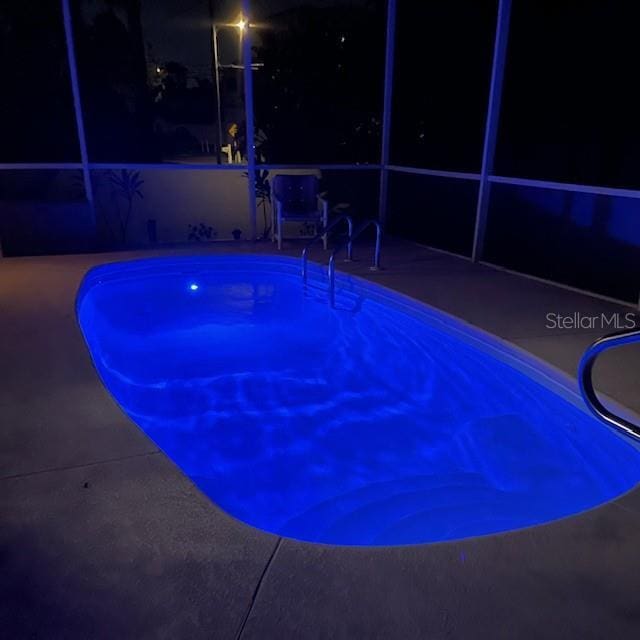 view of pool at night