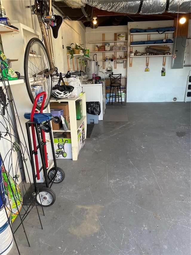 garage featuring water heater, washer / dryer, and electric panel