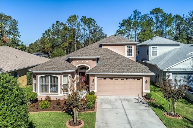 view of front of property featuring a garage and a front yard