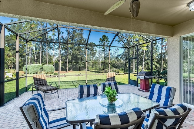 view of patio / terrace featuring ceiling fan, a lanai, and area for grilling