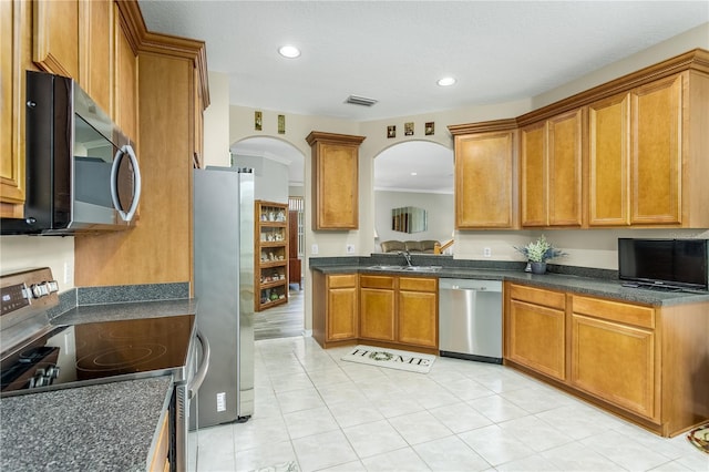 kitchen with stainless steel appliances, sink, and light tile patterned floors