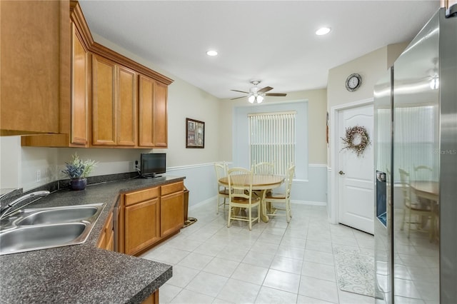 kitchen featuring light tile patterned flooring, sink, built in desk, stainless steel fridge with ice dispenser, and ceiling fan