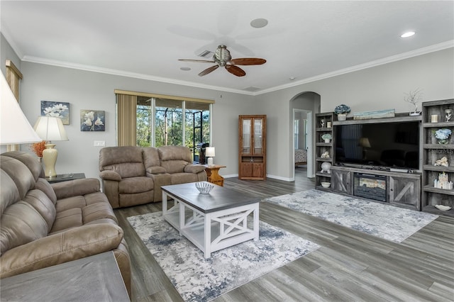 living room with crown molding, dark hardwood / wood-style floors, and ceiling fan