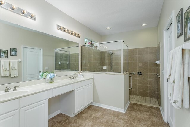 bathroom with vanity, an enclosed shower, and tile patterned flooring