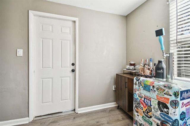 laundry area featuring light wood-type flooring