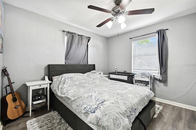 bedroom featuring ceiling fan and dark hardwood / wood-style floors