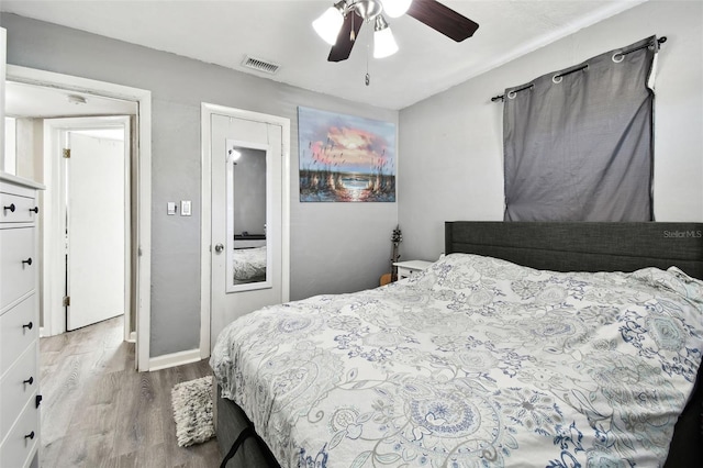 bedroom with ceiling fan and light hardwood / wood-style floors