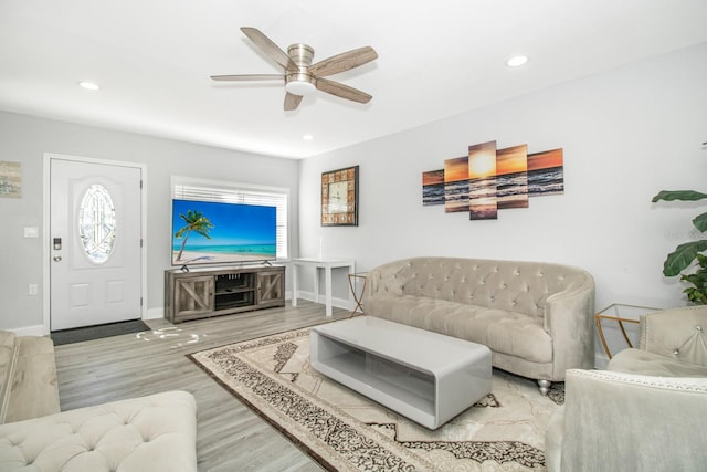 living room with ceiling fan and wood-type flooring