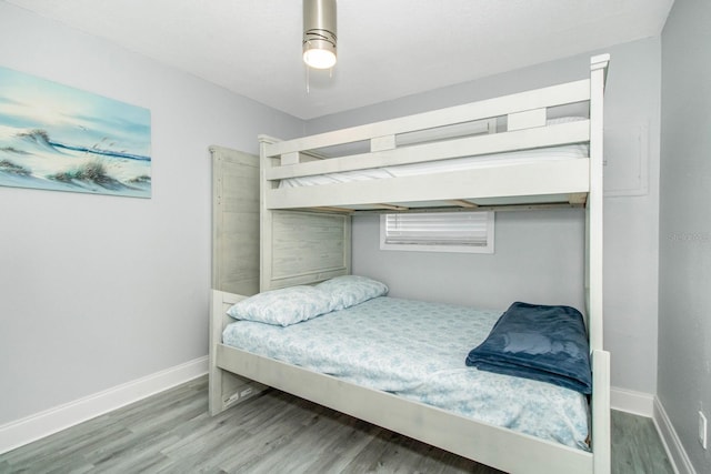 bedroom with ceiling fan and hardwood / wood-style flooring