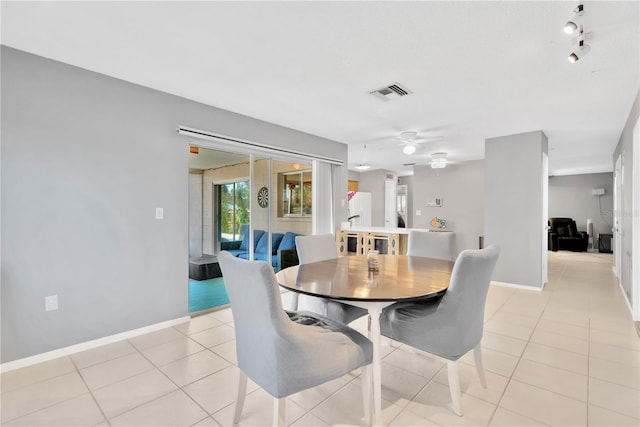 tiled dining area featuring ceiling fan