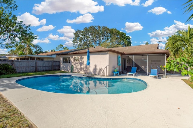 view of pool featuring a sunroom and a patio