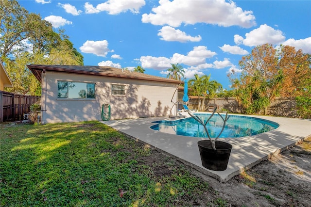 view of swimming pool featuring a yard and a patio area