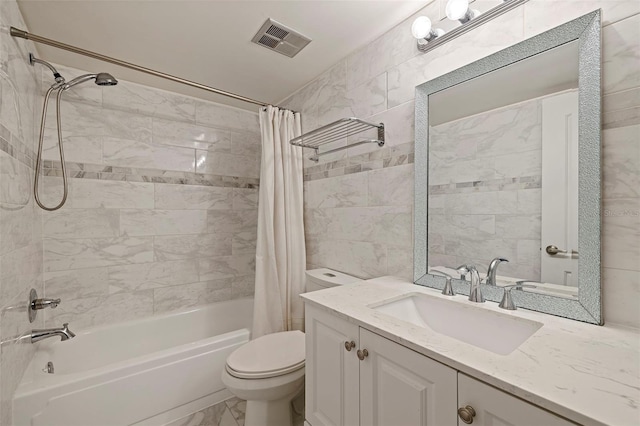 full bathroom with vanity, shower / tub combo, and toilet