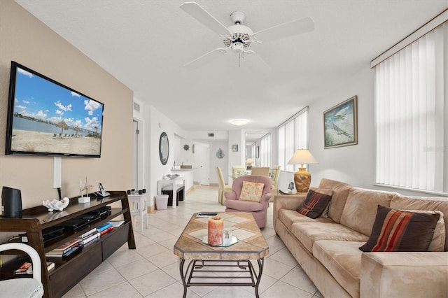 living room featuring ceiling fan and light tile patterned floors