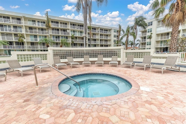 view of swimming pool featuring a community hot tub