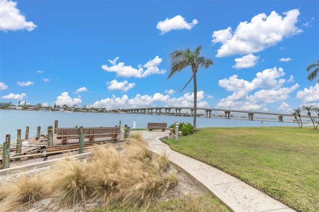 dock area featuring a water view and a yard