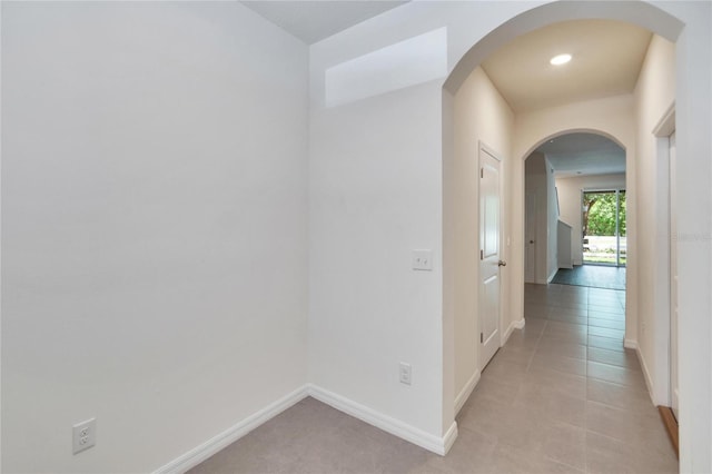 hall with light tile patterned floors