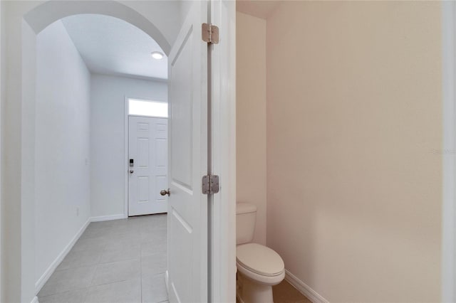 bathroom featuring tile patterned flooring and toilet