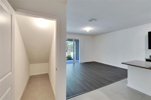 interior space with a textured ceiling and light hardwood / wood-style flooring