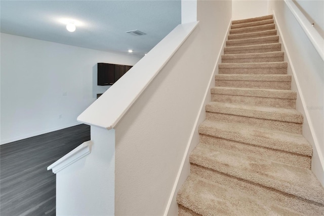 stairway with hardwood / wood-style floors