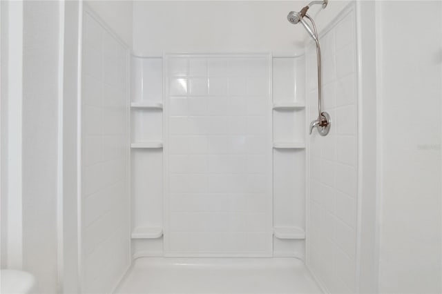 bathroom with a tile shower