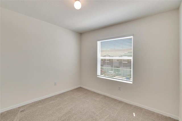 unfurnished room featuring light colored carpet