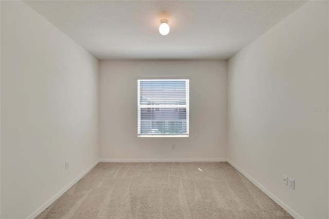 carpeted empty room with a textured ceiling