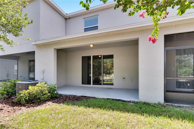 property entrance with a patio and cooling unit