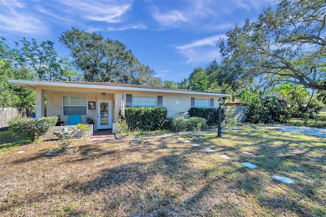 ranch-style house featuring a front lawn