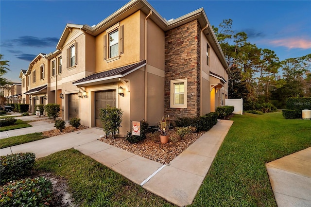 view of front facade featuring a lawn and a garage