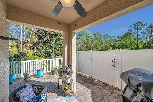 view of patio featuring ceiling fan and a grill