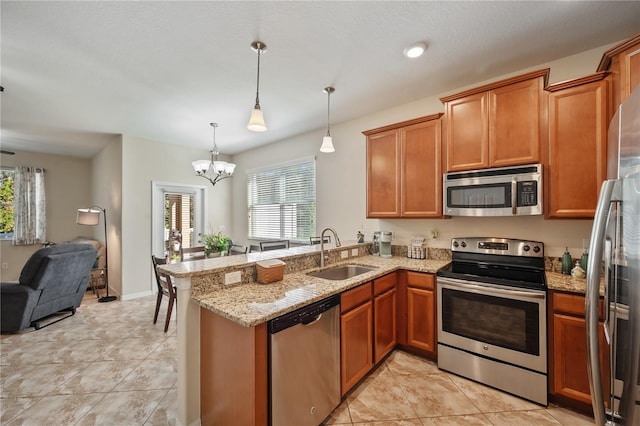 kitchen with plenty of natural light, kitchen peninsula, sink, and appliances with stainless steel finishes