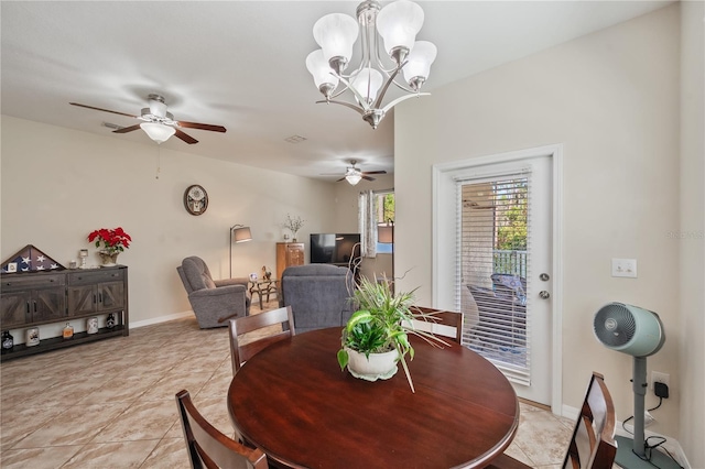 tiled dining area featuring ceiling fan with notable chandelier