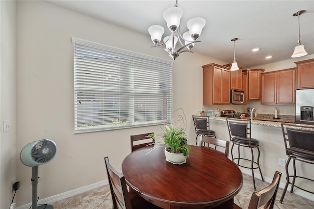 dining space featuring light tile patterned flooring and a chandelier