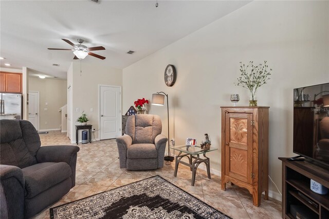 living room featuring ceiling fan and light tile patterned floors