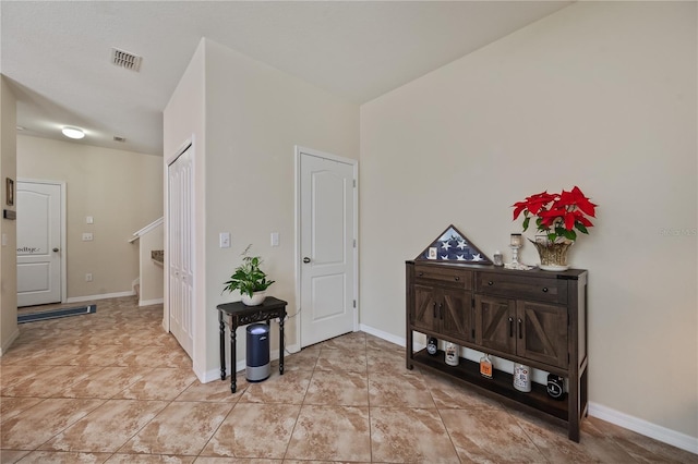 hall featuring light tile patterned floors