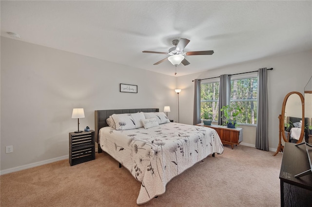 bedroom featuring ceiling fan and light colored carpet