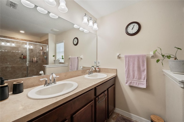 bathroom featuring vanity and an enclosed shower