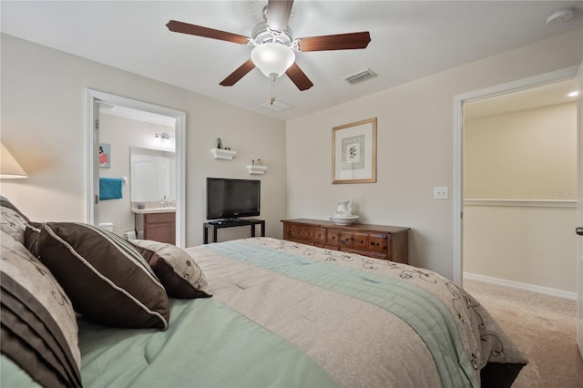 carpeted bedroom featuring ceiling fan and ensuite bathroom