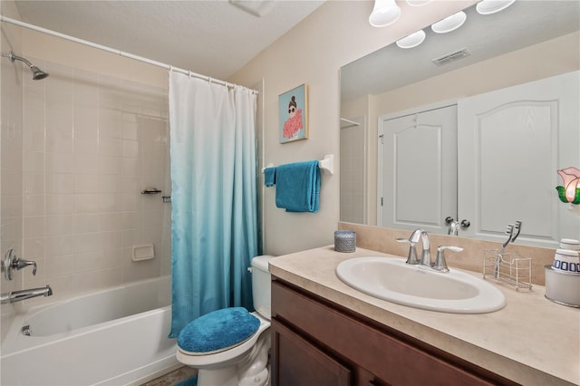 full bathroom featuring shower / bath combo, toilet, a textured ceiling, and vanity