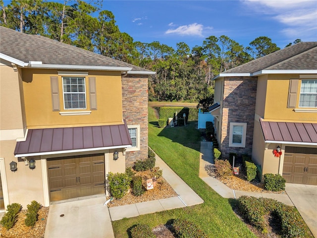 view of front of house with a front yard and a garage