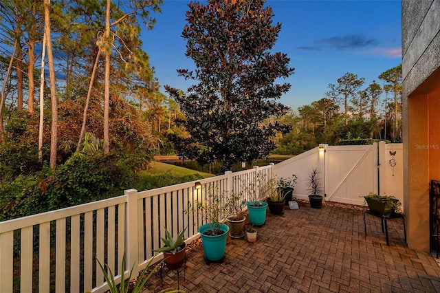 view of patio terrace at dusk