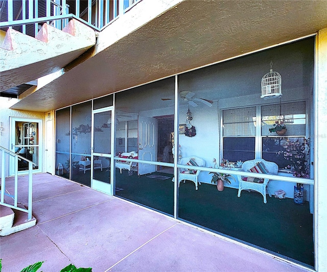 view of patio / terrace with ceiling fan and a balcony