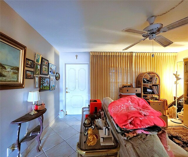 living room with ceiling fan and light tile patterned flooring