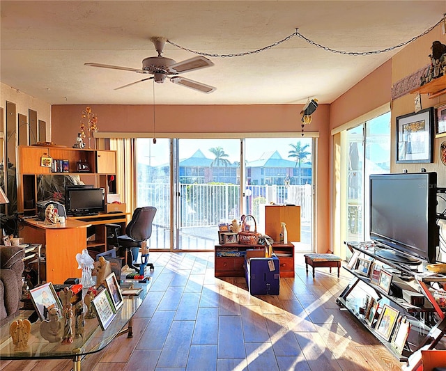 home office featuring ceiling fan, a healthy amount of sunlight, and light hardwood / wood-style flooring