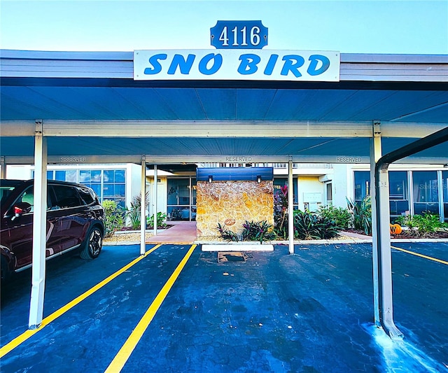 view of parking / parking lot featuring a carport