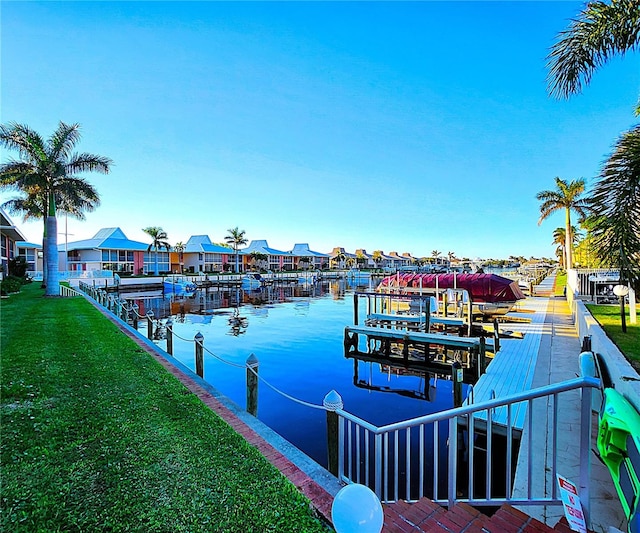 view of dock featuring a yard and a water view