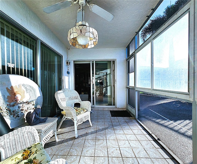 sunroom / solarium featuring ceiling fan